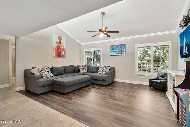 living area with lofted ceiling, plenty of natural light, ornamental molding, and wood finished floors