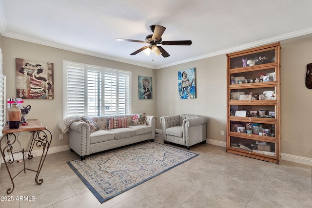 living room with ornamental molding, baseboards, and a ceiling fan