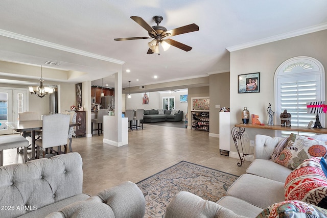 living room featuring light tile patterned floors, ornamental molding, a raised ceiling, and baseboards