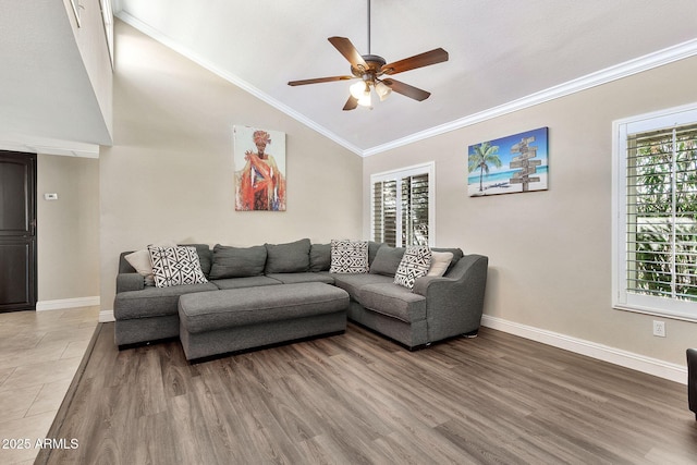 living area featuring light wood-style floors, ceiling fan, baseboards, and crown molding