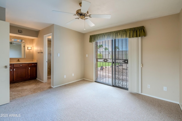 unfurnished bedroom with baseboards, visible vents, access to outside, light colored carpet, and connected bathroom