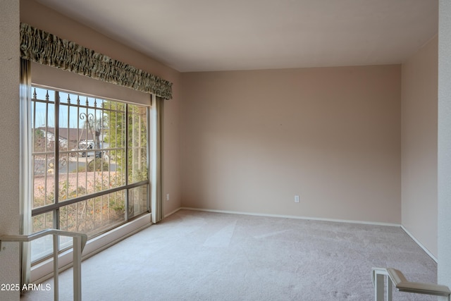 carpeted spare room with baseboards