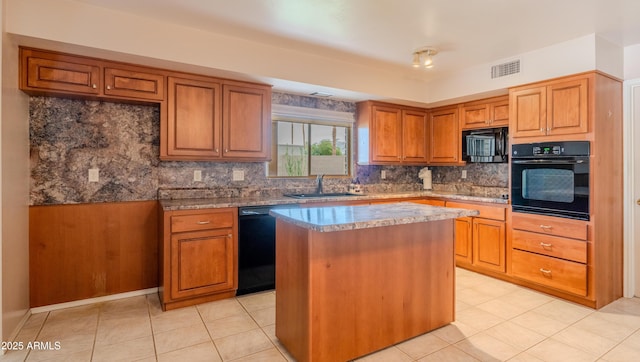 kitchen featuring black appliances, a sink, a kitchen island, brown cabinetry, and decorative backsplash