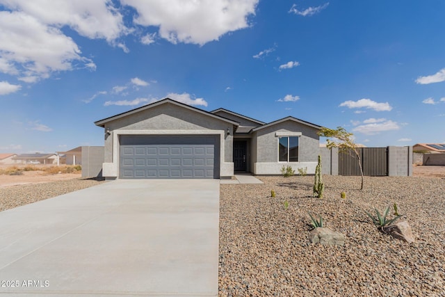 single story home featuring a garage, concrete driveway, and stucco siding