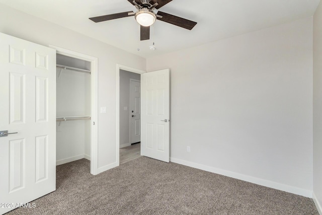 unfurnished bedroom with a closet, carpet flooring, ceiling fan, and baseboards