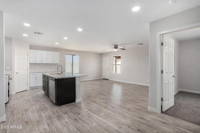 kitchen featuring visible vents, white cabinets, open floor plan, light countertops, and light wood-type flooring