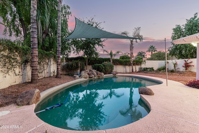 view of pool at dusk