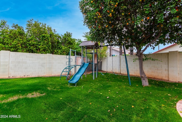 view of jungle gym with a lawn