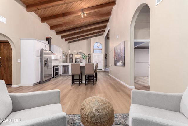 living room with beam ceiling, light wood-type flooring, high vaulted ceiling, and wooden ceiling