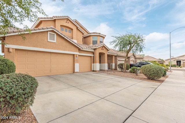 mediterranean / spanish-style house featuring a garage