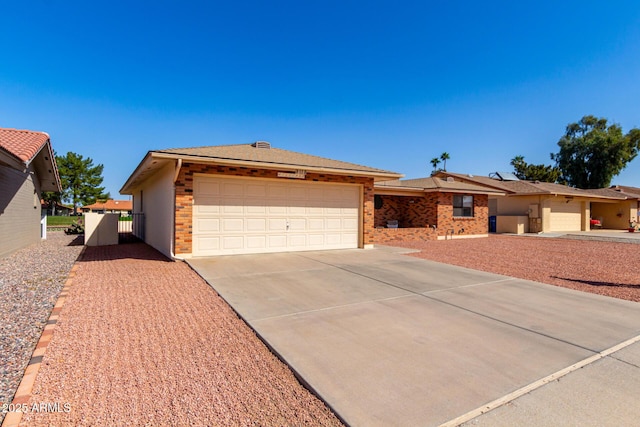 ranch-style home with a garage, concrete driveway, and brick siding