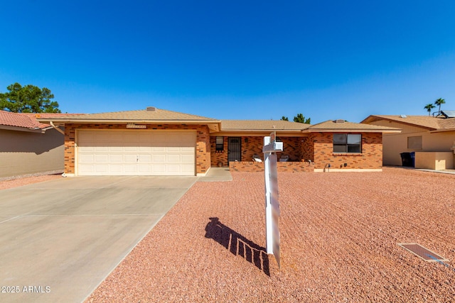 single story home featuring a garage, concrete driveway, and brick siding