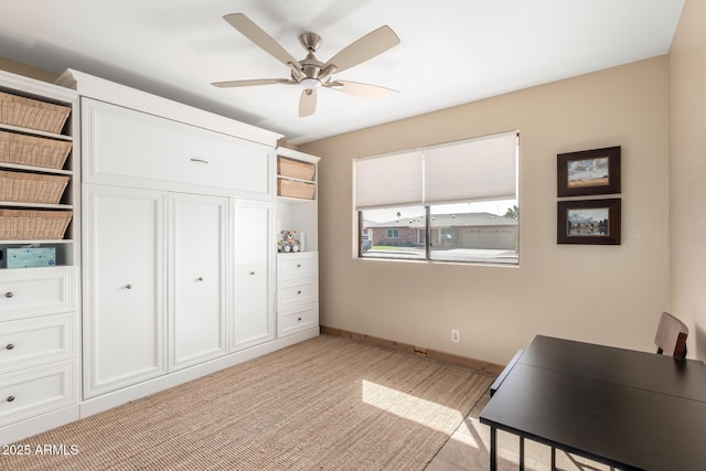 home office with ceiling fan and baseboards