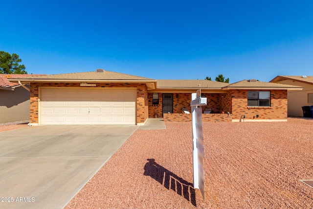 ranch-style home featuring a garage, driveway, and brick siding