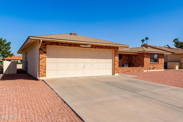 single story home featuring an attached garage, fence, concrete driveway, and brick siding