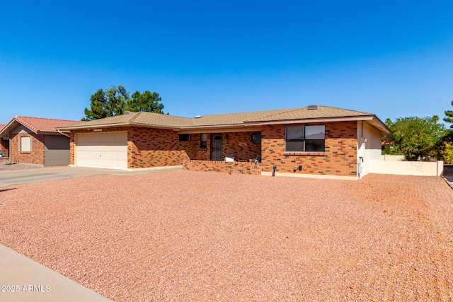 ranch-style home with concrete driveway, brick siding, and an attached garage