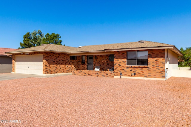 ranch-style house with an attached garage, concrete driveway, and brick siding