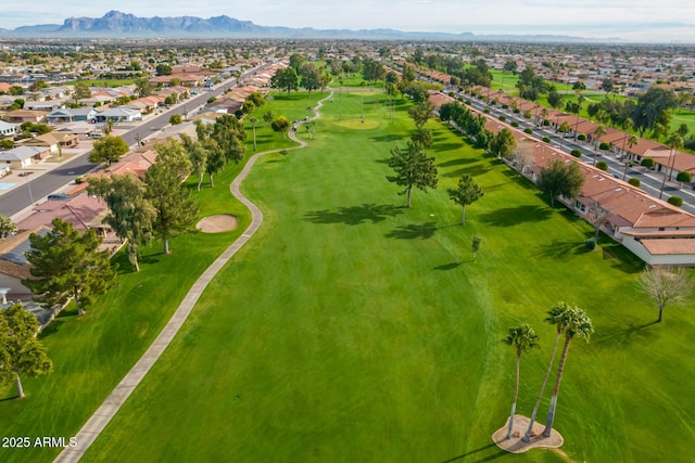 birds eye view of property with view of golf course, a residential view, and a mountain view