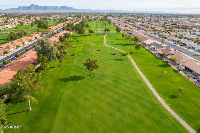 aerial view with a residential view, a mountain view, and golf course view