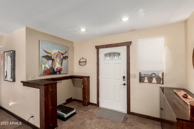 entrance foyer featuring baseboards and recessed lighting