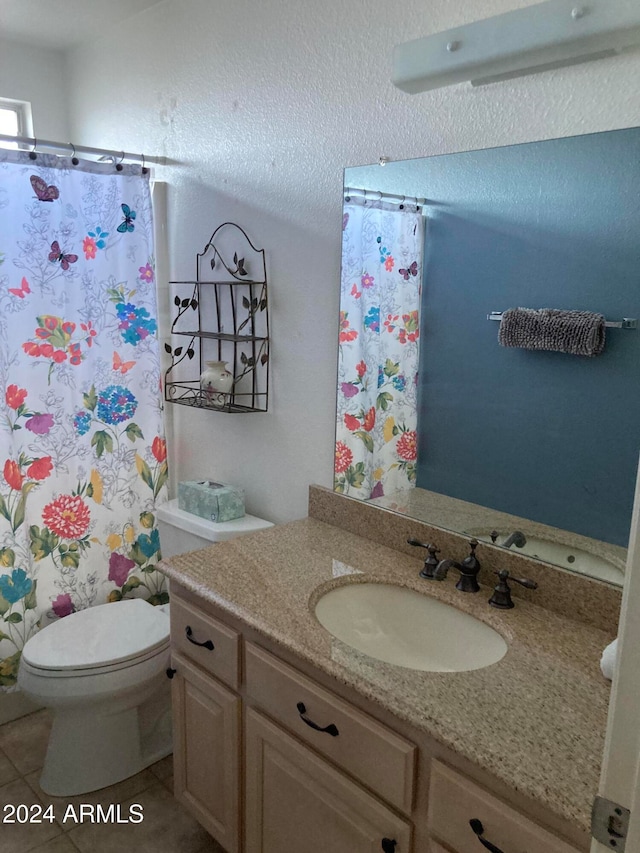 bathroom featuring vanity, toilet, tile patterned floors, and curtained shower