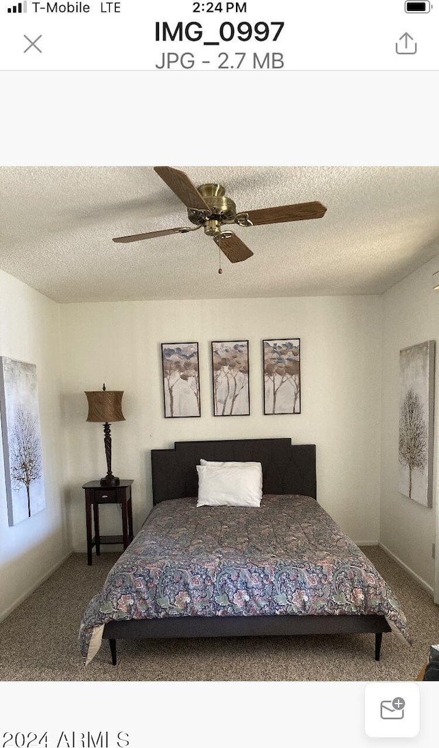 bedroom featuring a textured ceiling, carpet flooring, and ceiling fan