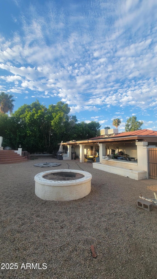 exterior space with a patio area and an outdoor fire pit