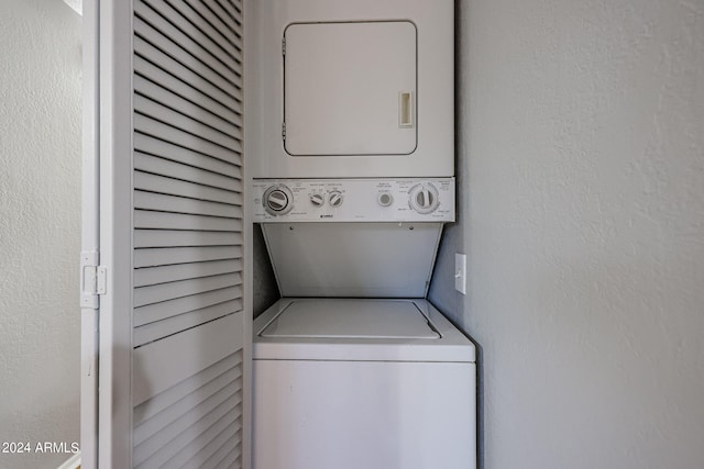 laundry room with stacked washing maching and dryer