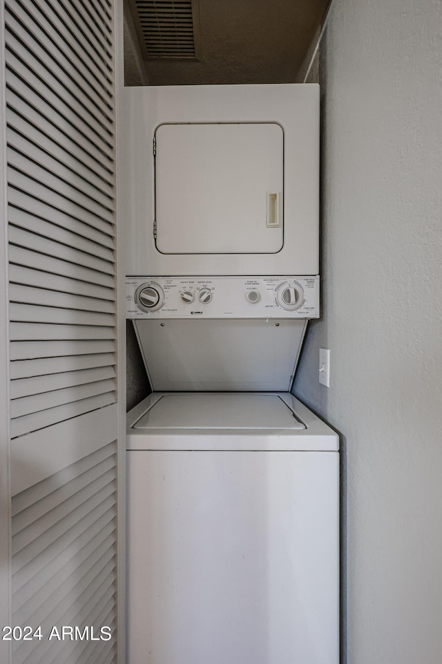 laundry area with stacked washer / drying machine