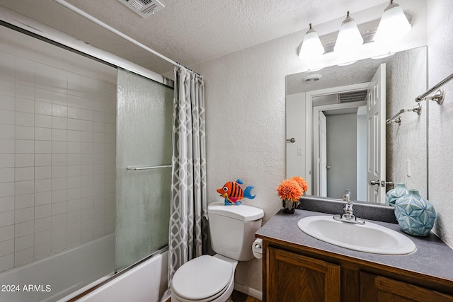 full bathroom with a textured ceiling, vanity, toilet, and shower / bath combo with shower curtain