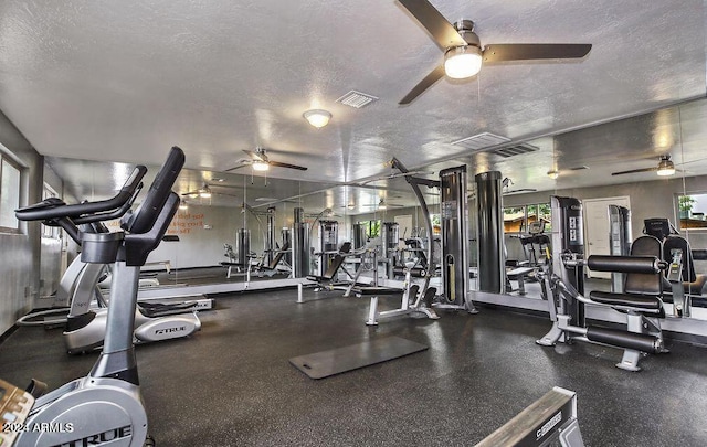 gym with a textured ceiling and ceiling fan