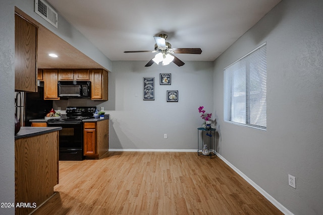 kitchen featuring ceiling fan, light hardwood / wood-style flooring, and black appliances