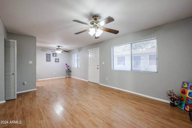 interior space with light hardwood / wood-style floors, ceiling fan, and plenty of natural light