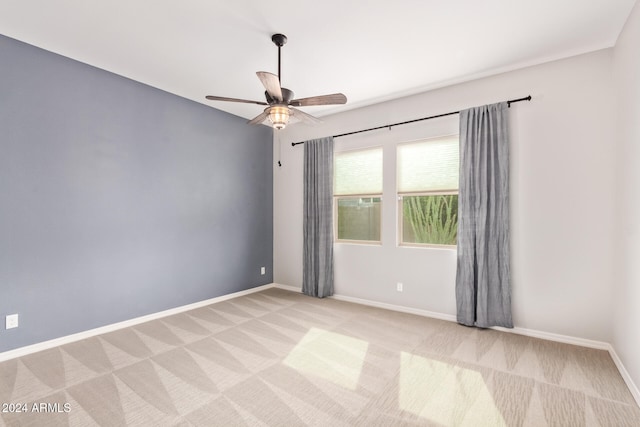 carpeted spare room with ceiling fan