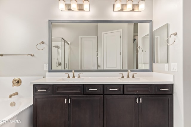 bathroom featuring vanity and separate shower and tub