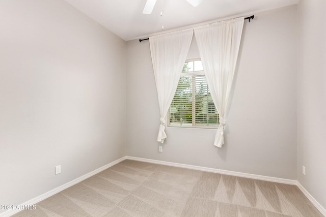 carpeted empty room with ceiling fan