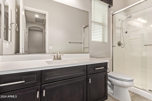 bathroom with walk in shower, tile patterned flooring, vanity, and toilet