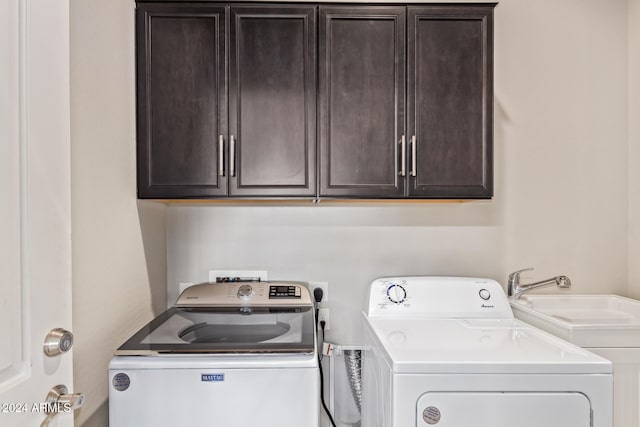 laundry room with cabinets, sink, and washer and dryer