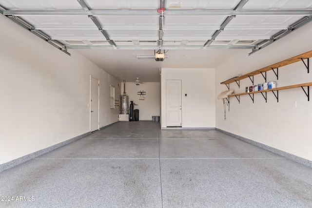 garage featuring water heater and a garage door opener