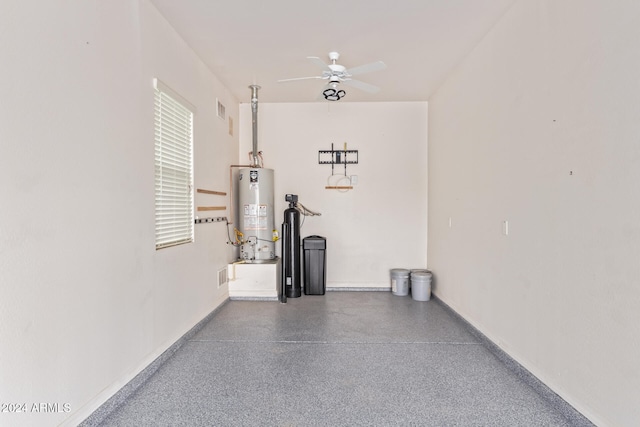 garage with gas water heater and ceiling fan