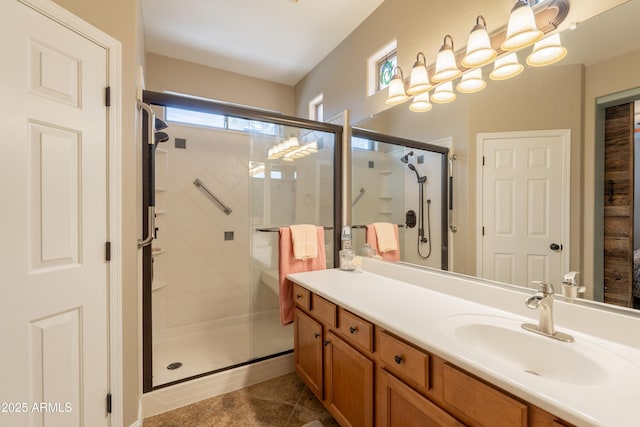 bathroom with a shower stall, vanity, and tile patterned floors
