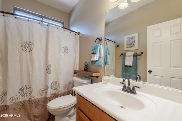 bathroom with toilet, vanity, and curtained shower
