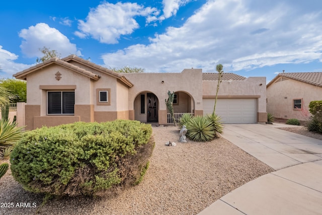 view of front of property featuring a garage, stucco siding, and concrete driveway