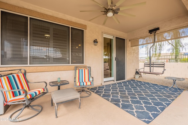 view of patio with a ceiling fan and fence
