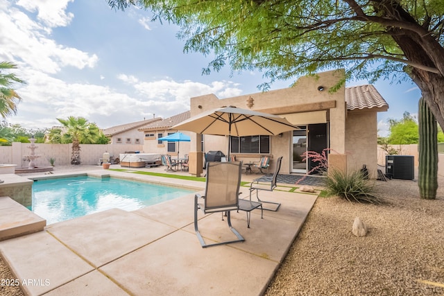 view of swimming pool featuring a hot tub, a patio area, central air condition unit, and a fenced backyard