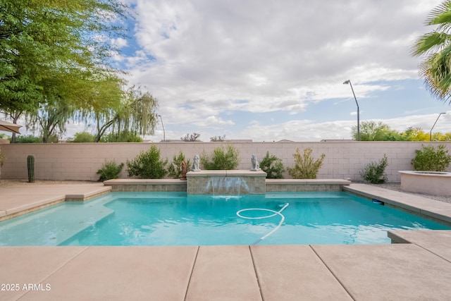 view of swimming pool with a fenced backyard