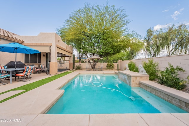 view of swimming pool featuring a fenced backyard, a patio area, and grilling area