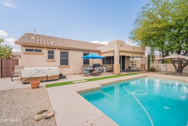 view of swimming pool featuring a patio area and fence