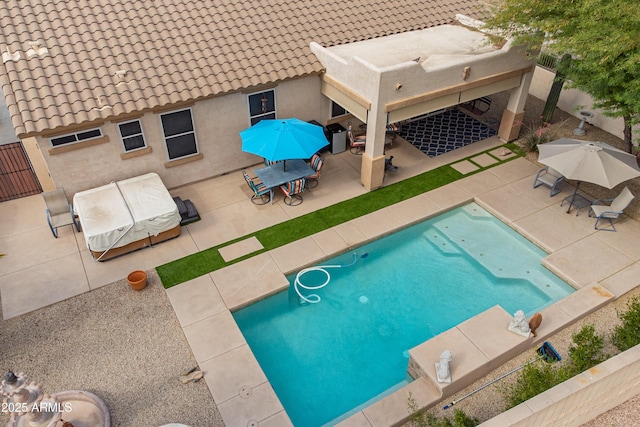 view of pool featuring a patio area and fence