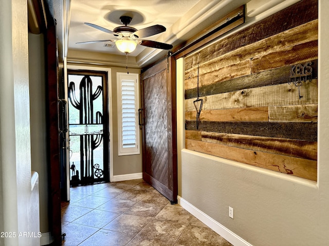 entrance foyer featuring ceiling fan, baseboards, wood walls, and tile patterned flooring